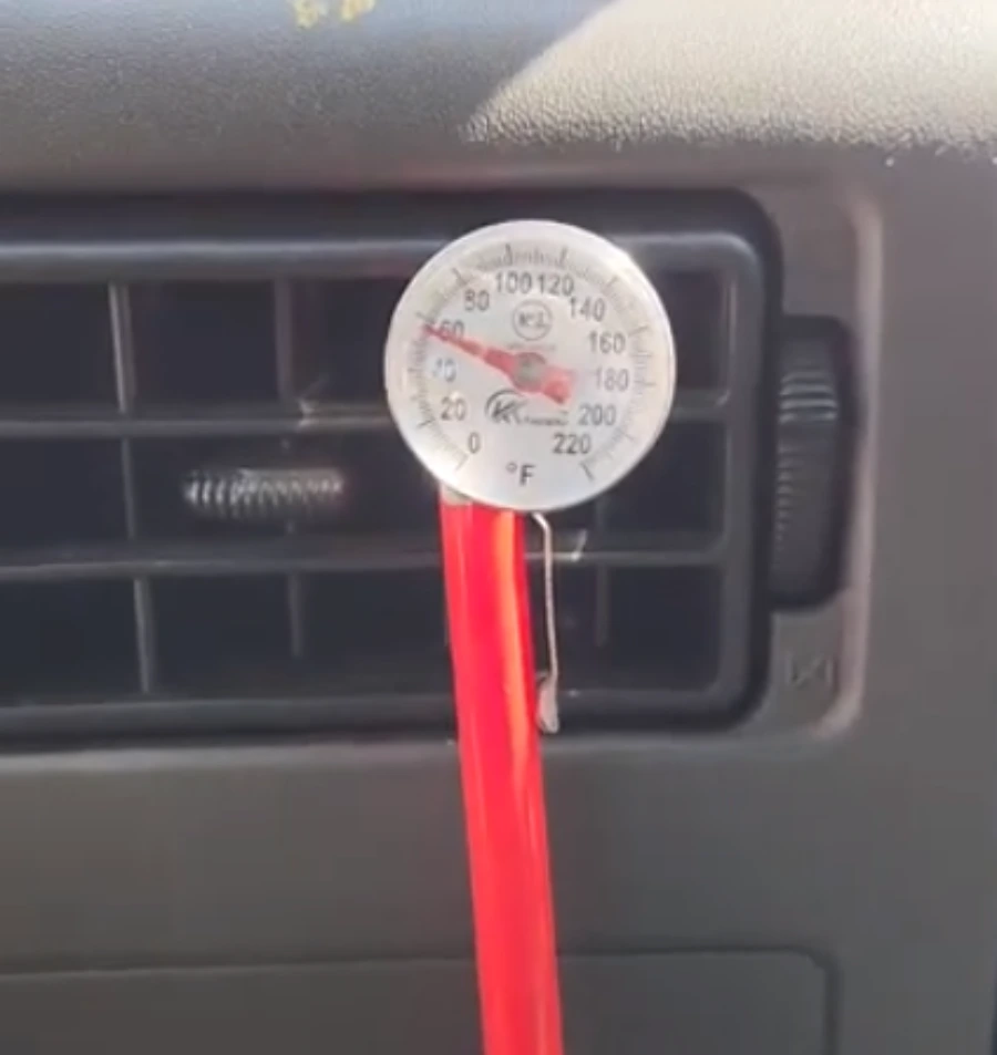 Thermometer in a dash vent measuring car AC output temperature