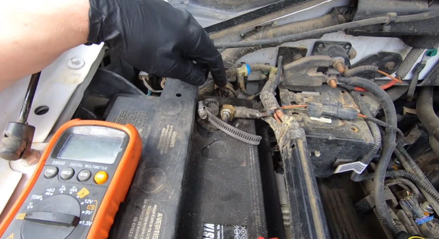 Multimeter testing battery voltage on a car that won't start